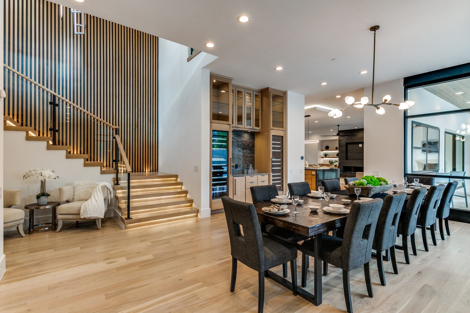 Dining and open staircase with wood slat screen